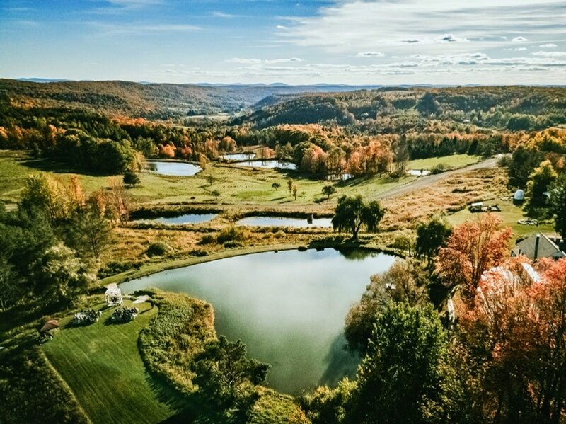 Aerial view of Twelve Ponds in autumn, the chain of ponds threaded through meadows and Catskills hills.