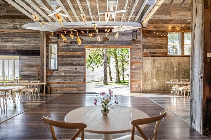 The barn at Twelve Ponds looking through the open doors to the lawn, dance floor and reclaimed wood walls.